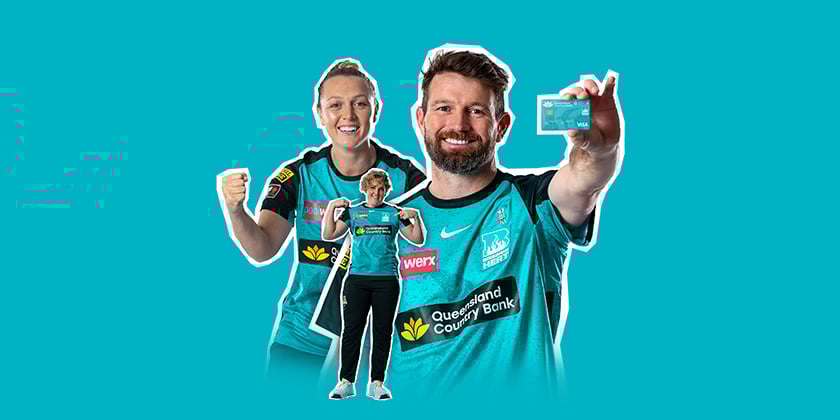Three Brisbane Heat players in teal jerseys holding a Queensland Country Bank Brisbane Heat Visa Debit card against a teal background.