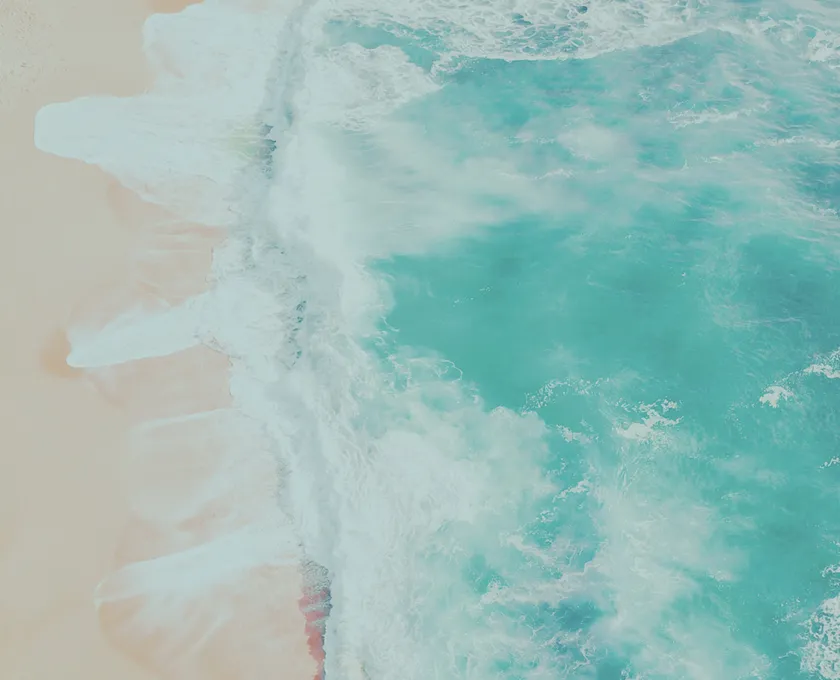 A blue ocean with white waves