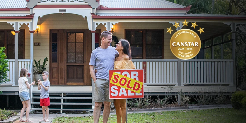 A couple stands in front of a traditional Queenslander-style home holding a large “Sold” sign, while two children play nearby in the yard. A Canstar award badge is displayed on the right side of the image.