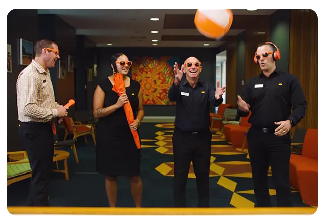 People playing with a beach ball inside Queensland Country Bank Head Office