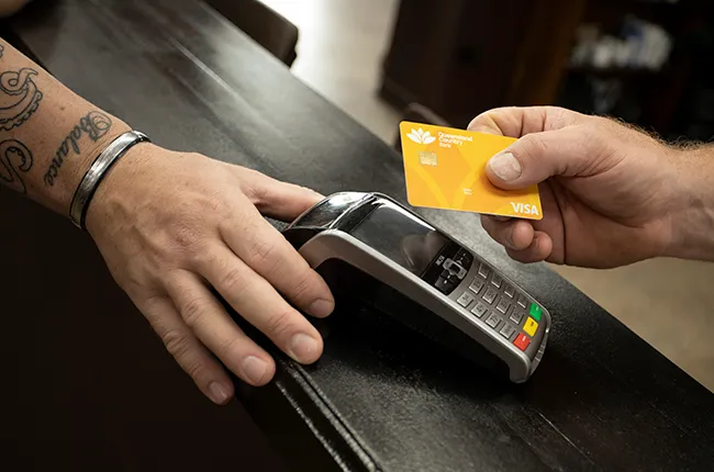 Close-up of a contactless payment being made at a checkout counter.