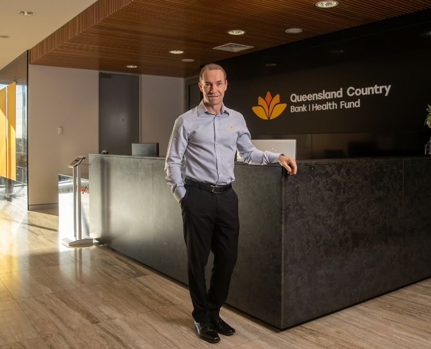 Queensland Country Bank CEO, Aaron Newman, standing out front Queensland Country Bank Head Office Reception.