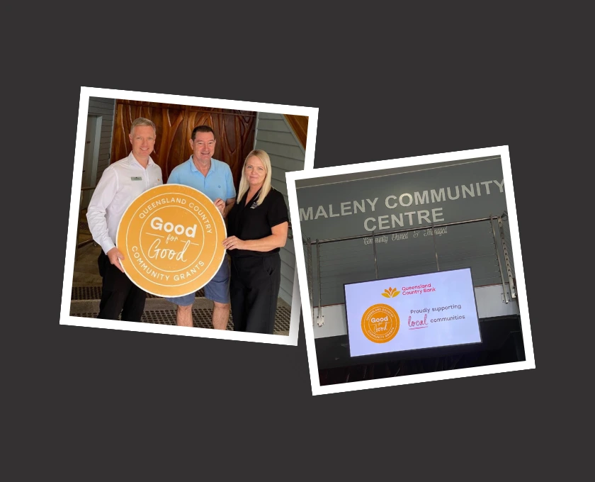 Community members holding a Good for Good Community Grants sign beside the exterior of the Maleny Community Centre.
