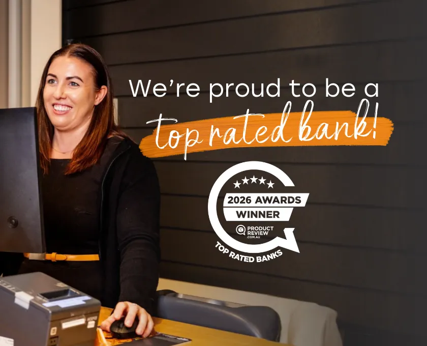 Promotional graphic showing a Queensland Country Bank staff member assisting at a service desk, alongside text reading ‘We’re proud to be a top rated bank!’ and the 2026 ProductReview Awards Top Rated Bank winner badge.