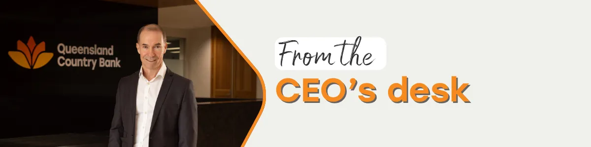 Queensland Country Bank CEO standing in front of the bank’s reception area with the Queensland Country Bank logo and text saying "From the CEO's desk".