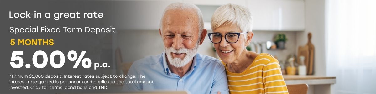Promotional banner for our special fixed term deposit offering 5.00% p.a. for 5 months, showing two people looking at a laptop.