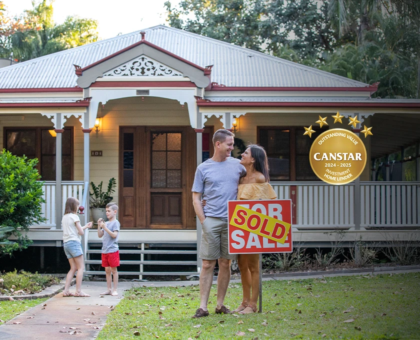A couple stands in front of a traditional Queenslander-style home holding a large “Sold” sign, while two children play nearby in the yard. A Canstar award badge is displayed on the right side of the image.